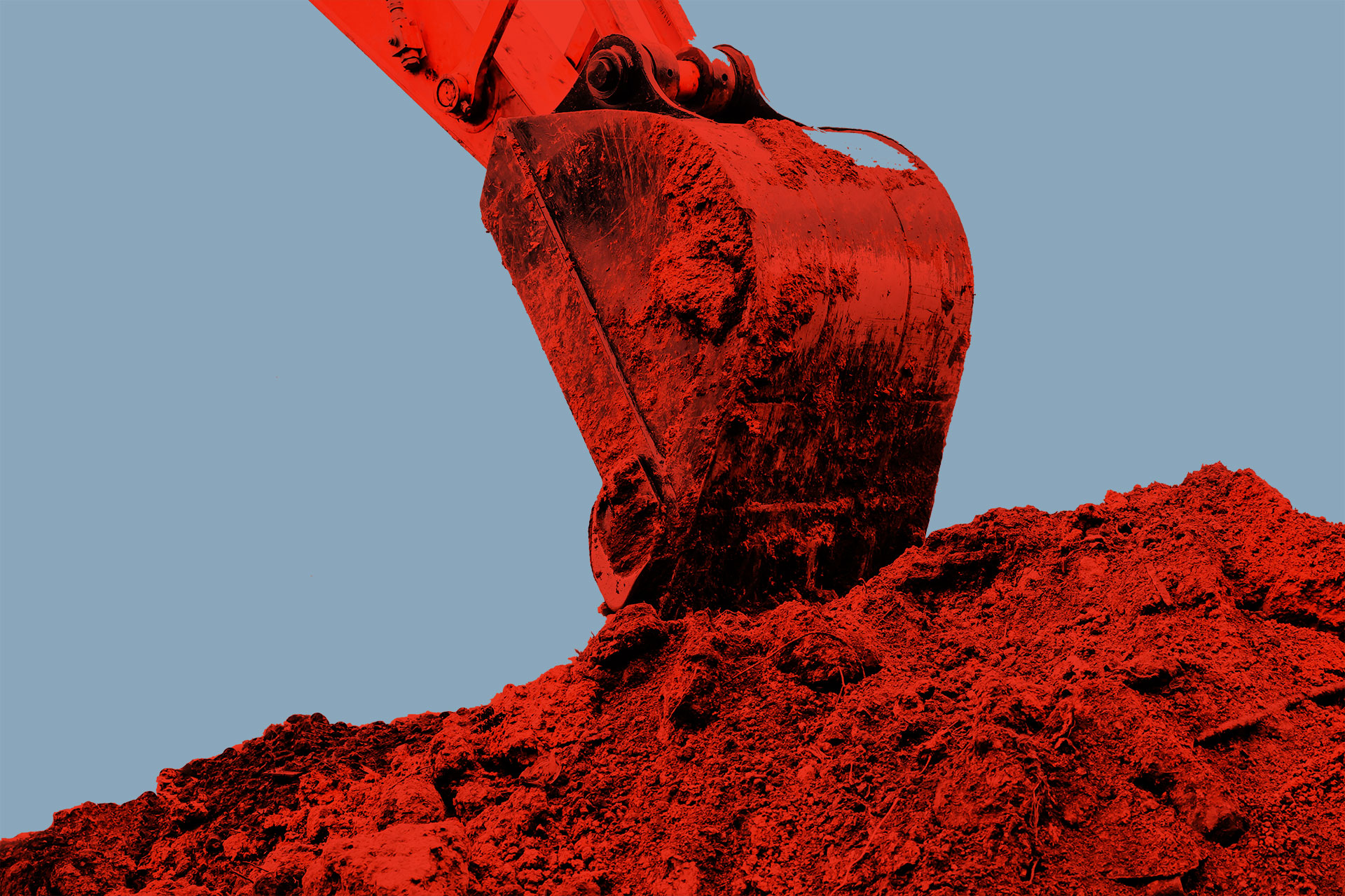 Excavator bucket digs clay soil