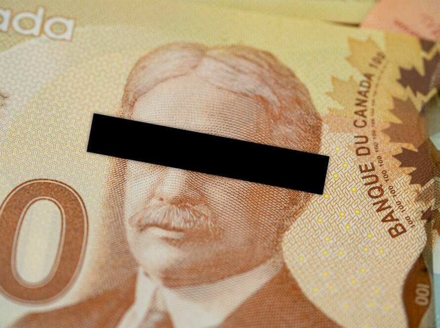 Close up of Canadian one hundred dollar banknote with black bar across Sir Robert Borden's eyes