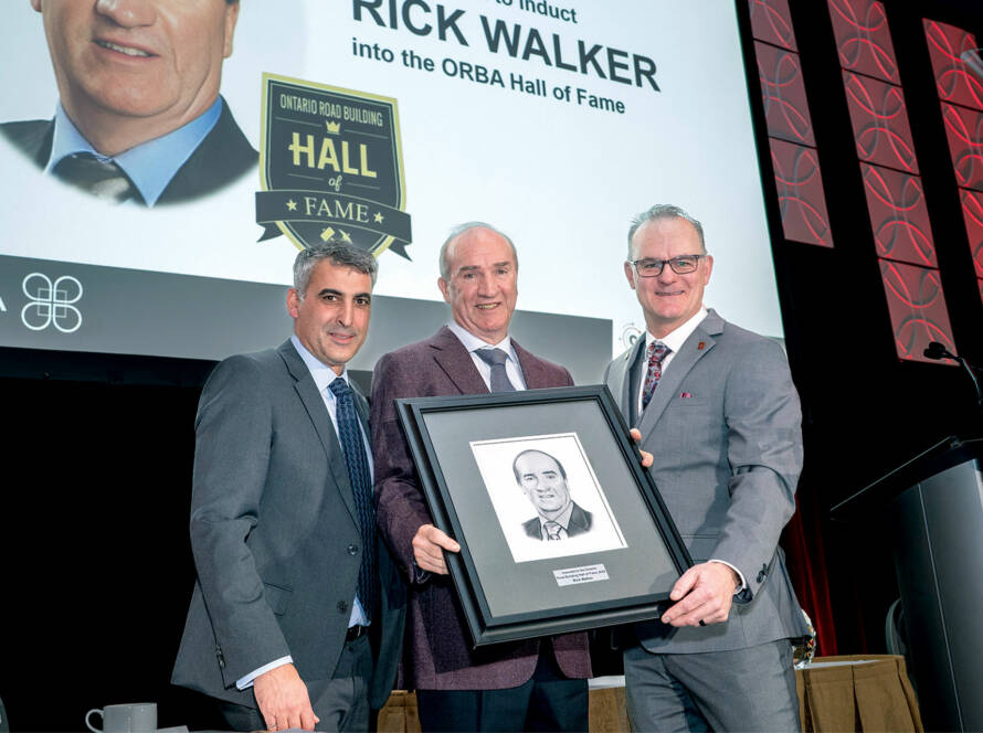 Malcolm Croskery, Rick Walker and Mark Mallett on stage with award